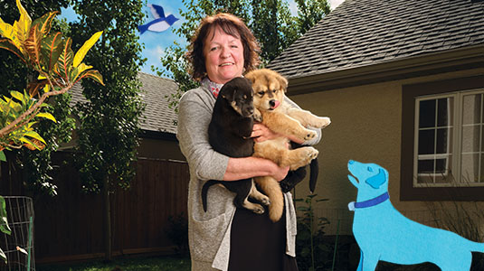 Woman holding two dogs