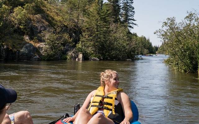 Image showing two people in a canoe paddelling down a water stream.