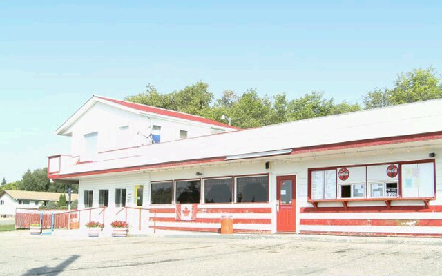 Image showing the exterior of a building painted white with red striped trim.